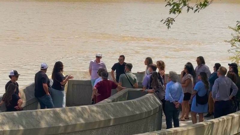 A group of visitors standing outside The Forks, listening to a Turtle Tours guide